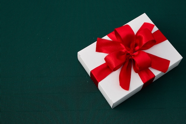 Gift Box with Ribbon on green paper