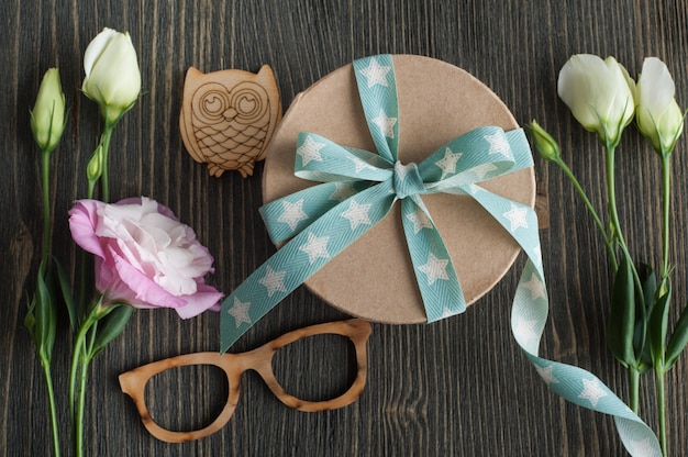 Gift box with star ribbon on dark rustic table