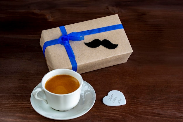 Gift box with a tag and a cup of coffee