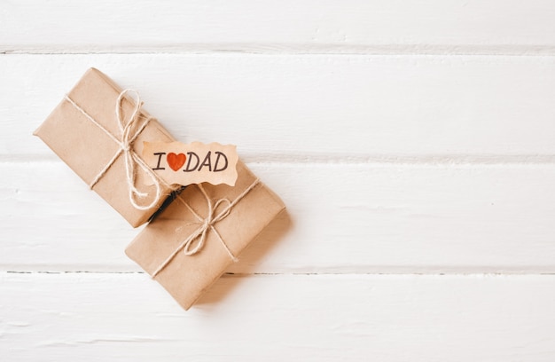 Gift box with a tag on white wooden space. father's day or birthday concept.