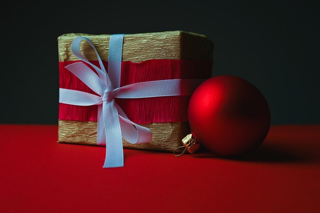 Gift box with white ribbon on dark background. High quality photo