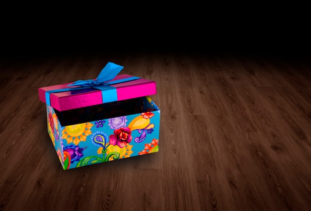 Gift box on wooden background.