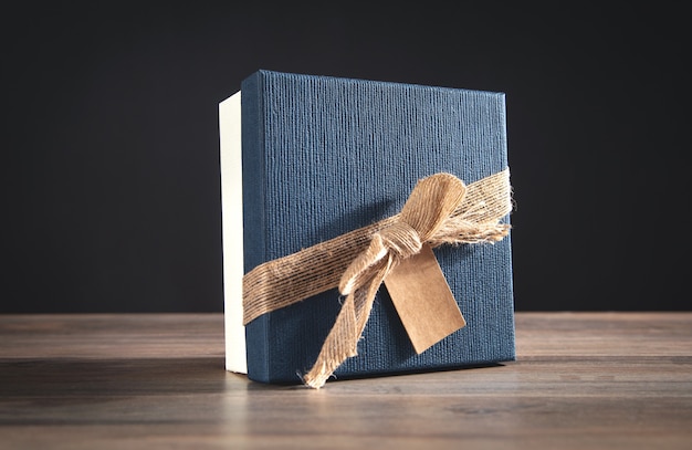 Gift box on the wooden background.