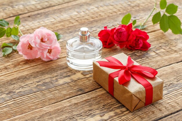 Gift box on wooden boards with rose flowers