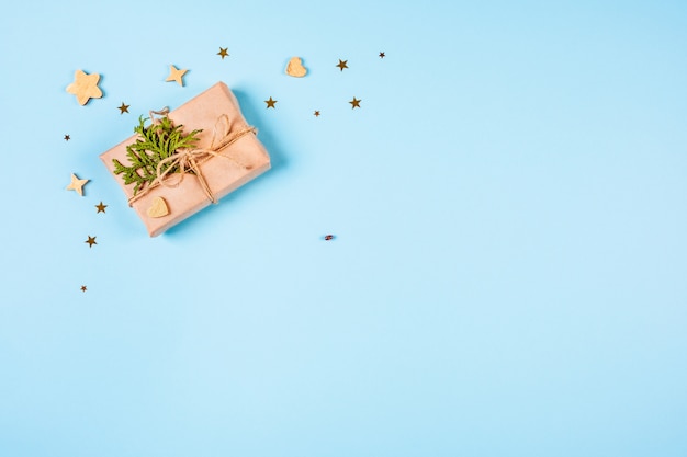 Gift box and wooden stars on blue