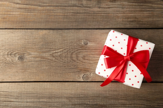 Gift box on wooden table top view