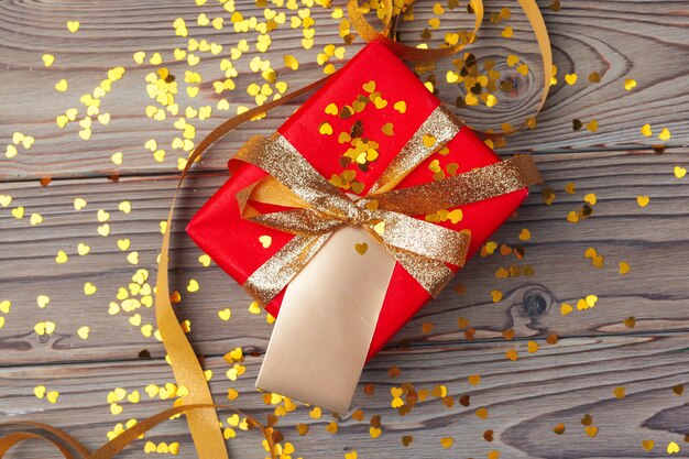 Gift box on wooden table, top view