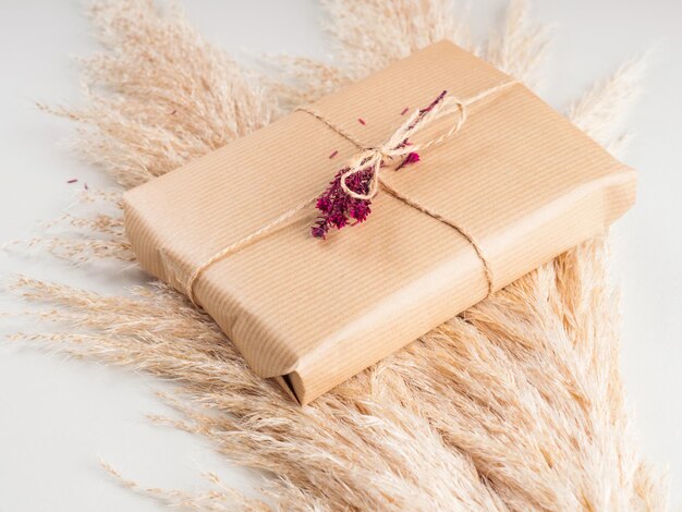 Gift Box Wrapped In Craft Paper With Dried Flowers