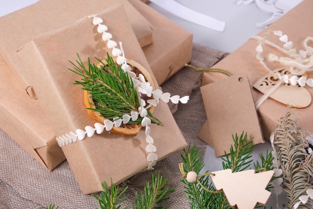 Gift box wrapped in eco paper, decorating gifts in eco style