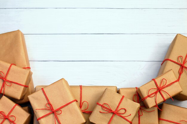 Gift box wrapped in recycled paper with red twine 