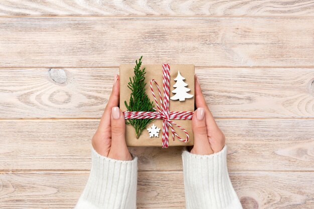 Gift box wrapped in recycled paper,  with ribbon bow,  with ribbon on rustic surface