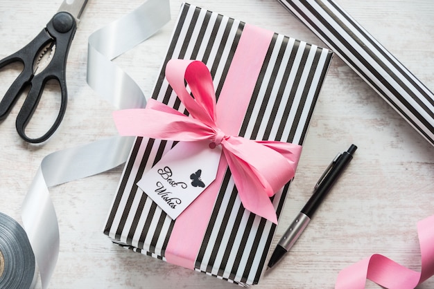 Gift box and wrapping materials on a white wood old background