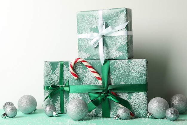 Gift boxes, candy cane and baubles on white