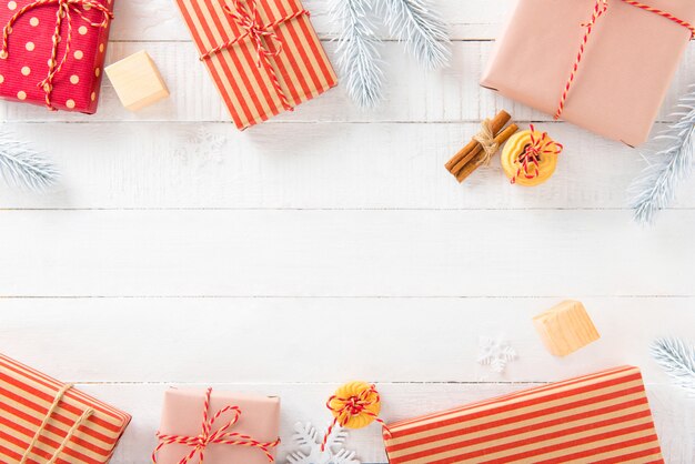 Gift boxes and Christmas ornaments on white wood background