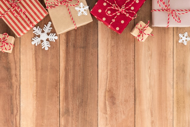 Gift boxes and Christmas ornaments on wood background