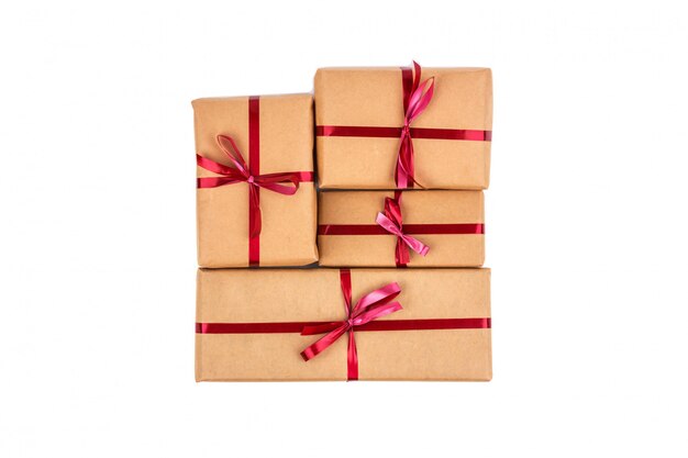 Gift Boxes in Craft Wrapping Paper with Red Ribbons isolated