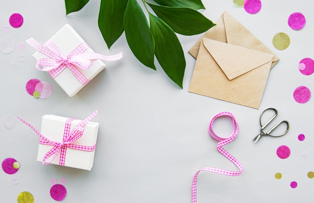 Gift boxes, envelope and with green leaves 