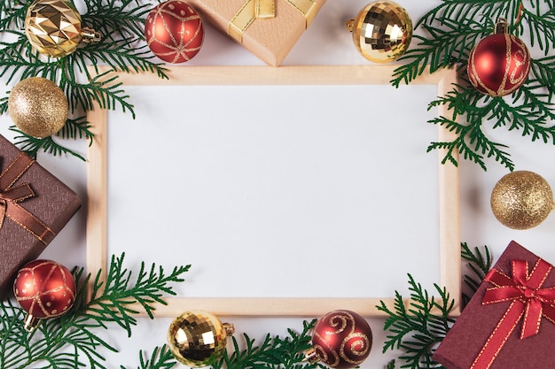 Gift boxes and gold festive decor on a white background. Mock up for Christmas advertisement.