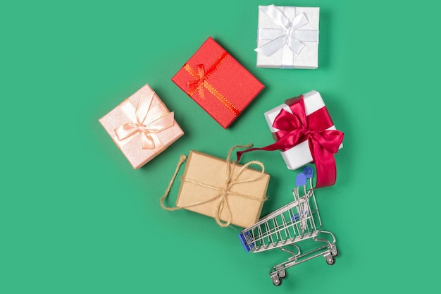 Gift boxes lie in a shopping basket Gift shopping concept online store