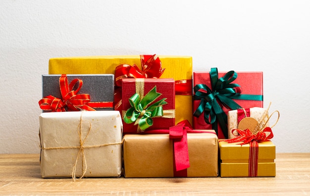 Photo gift boxes presents with ribbon on the table, white background. front view with copy space.