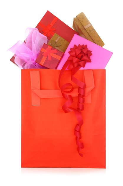 Gift boxes in a red shopping bag on white background