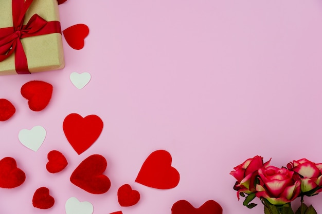 gift boxes, roses and hearts on wooden table