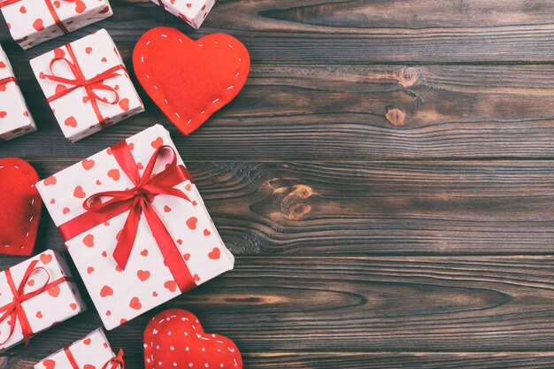 Gift boxes and textile hearts on wood