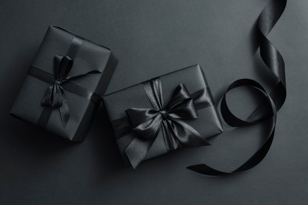 Gift boxes with black bows on black 