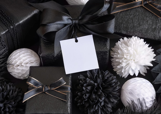 Gift Boxes with Black and white paper flowers and decorations square gift tag Mockup