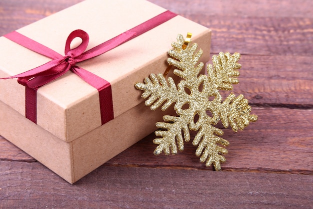 Gift boxes with bow and christmas decoration on wood surface