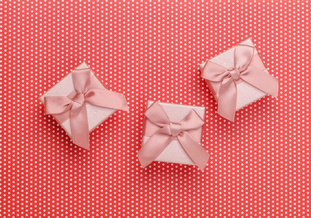 Gift boxes with bows on a red polka dot.