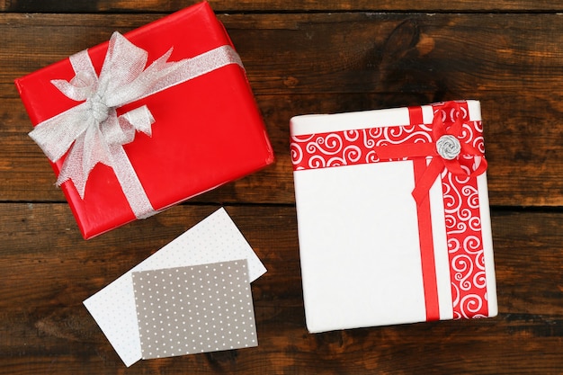 Gift boxes with card on wooden background