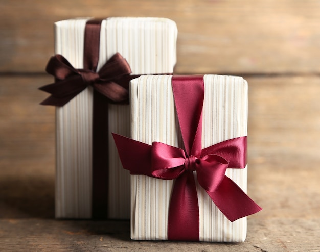 Gift boxes with colorful ribbon on wooden surface