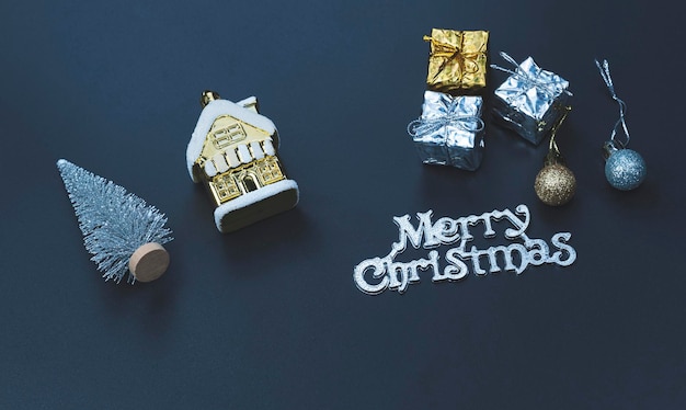 Gift boxes with decorative equipment and merry Christmas text on black board in blue night style