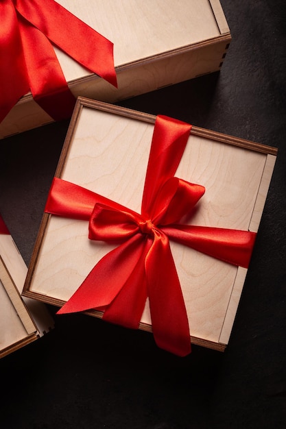 Gift boxes with red ribbon on a black background