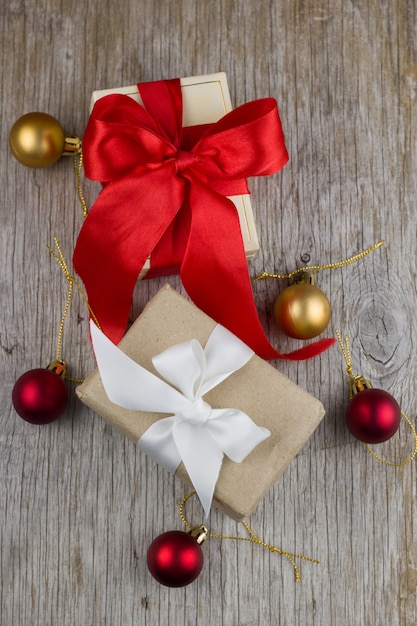 Gift boxes with red and white satin ribbons  on the wooden table