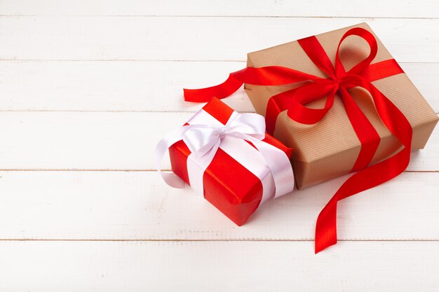 Gift boxes with ribbon on white table close up