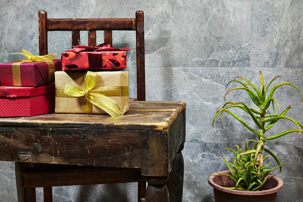 Photo gift boxes on wood old table with plant pot preparation for holidays