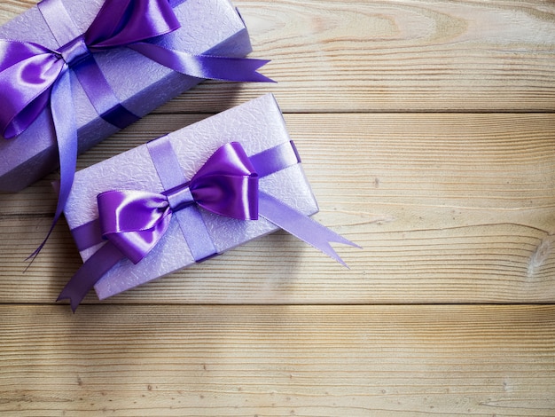 Gift boxes on the wooden board top view