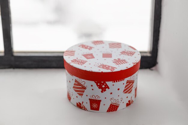 A gift in a festive box in white on the windowsill. High quality photo