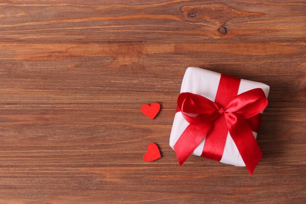 gift and flowers on a colored background holiday give a gift congratulations
