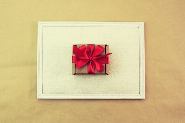 Gift in Kraft box red bow congratulations Top view copy space