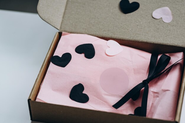 Photo gift kraft box with pink wrapping paper and black ribbon mockup preparation for valentines day g