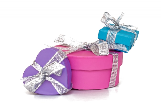 Gift multicolored boxes wrapped in recycled paper with ribbon isolated on white