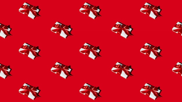 Gift pattern. Red seamless background. Women day. Care package. Festive decorative composition. Presents wrapped in white boxes with ribbon bows isolated on bright color.