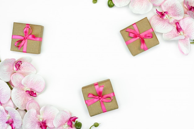 Gift present boxes with  pink ribbon and orchid flowers