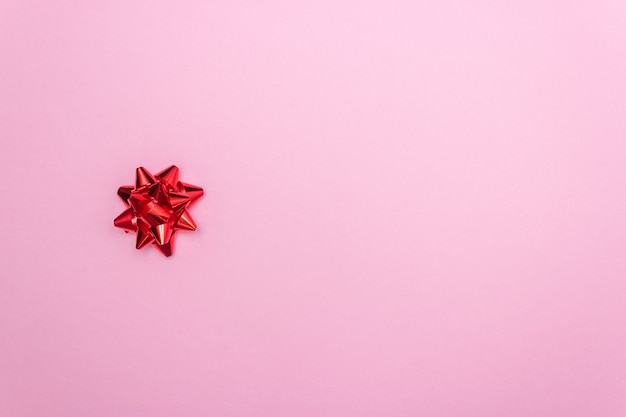 Gift red bow on a pink background