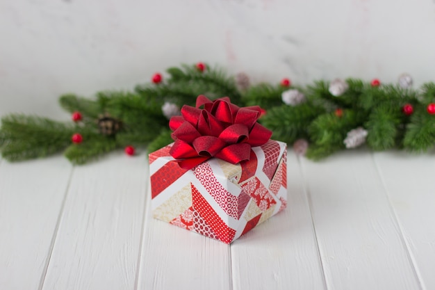 Gift in red and white paper on a white table