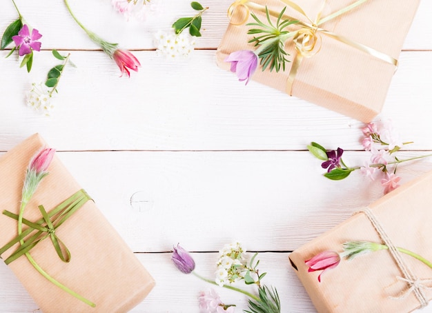 Gift and roses on wooden white background Workspace Top view flat lay