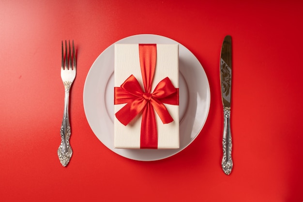 Gift on a serving plate on a red wall